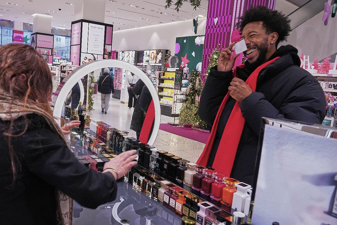 Ivan Leon chooses from Tom Ford fragrances at a Nordstrom department store, in New York, Monday, Dec. 8, 2025. (AP Photo/Richard Drew)