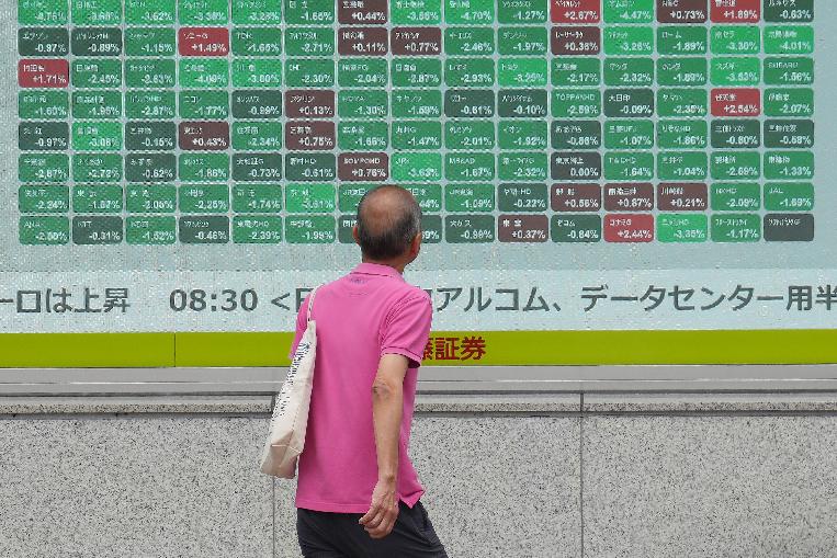 A person looks at an electronic stock board showing Japan's Nikkei index at a securities firm Tuesday, June 2, 2026, in Tokyo. (AP Photo/Eugene Hoshiko)