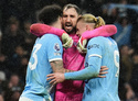 Manchester City's goalkeeper Gianluigi Donnarumma, center, celebrates with Nico O'Reilly, left, and Erling Haaland after the English Premier League soccer match between Manchetser City and Newcastle in Manchester, England, Saturday, Feb. 21, 2026. (Martin Rickett/PA via AP)