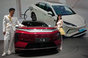 FILE - Models stand next to a latest EV car from Chinese automaker BYD showcased at the Auto China 2026, in Beijing, April 25, 2026. (AP Photo/Andy Wong, File)