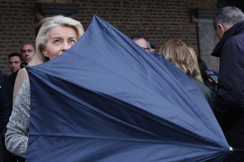 European Commission President Ursula von der Leyen opens her umbrella as she prepares to walk toward a group photo opportunity during the EU summit at Alden Biesen Castle in Bilzen-Hoeselt, Belgium, Thursday, Feb. 12, 2026. (AP Photo/Omar Havana)