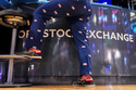 Specialist Michael Pistillo wears pants adorned with American flags as he works on the floor of the New York Stock Exchange, Friday, May 22, 2026. (AP Photo/Richard Drew)