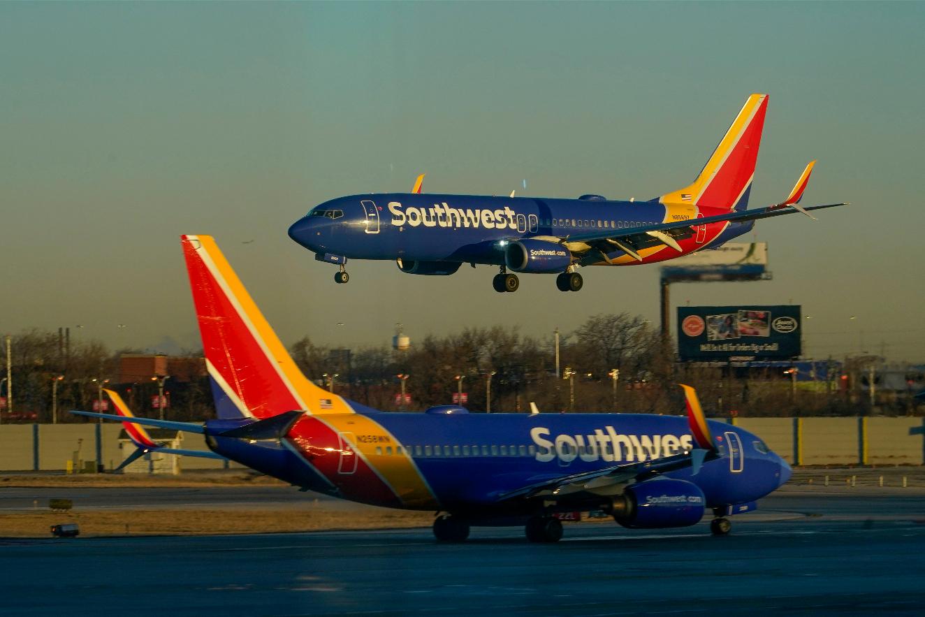 FILE - A Southwest Airlines plane prepares to land at Midway International Airport while another taxis on the ground, Feb. 12, 2023, in Chicago. (AP Photo/Kiichiro Sato, File)