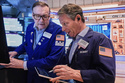 Specialist Patrick King, left, and trader Robert Charmak work on the floor of the New York Stock Exchange, Thursday, Feb. 19, 2026. (AP Photo/Richard Drew)