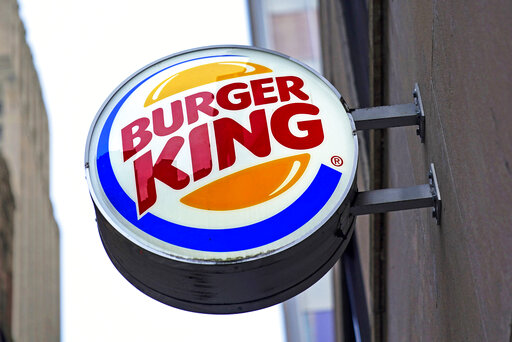 FILE - The Burger King logo is displayed on a sign outside a restaurant in downtown Pittsburgh on Wednesday, Jan. 12, 2022. On Friday, Sept. 9, 2022, the company said it plans to invest $400 million in its U.S. restaurants over the next two years to update its stores and boost flagging sales. (AP Photo/Gene J. Puskar, File)