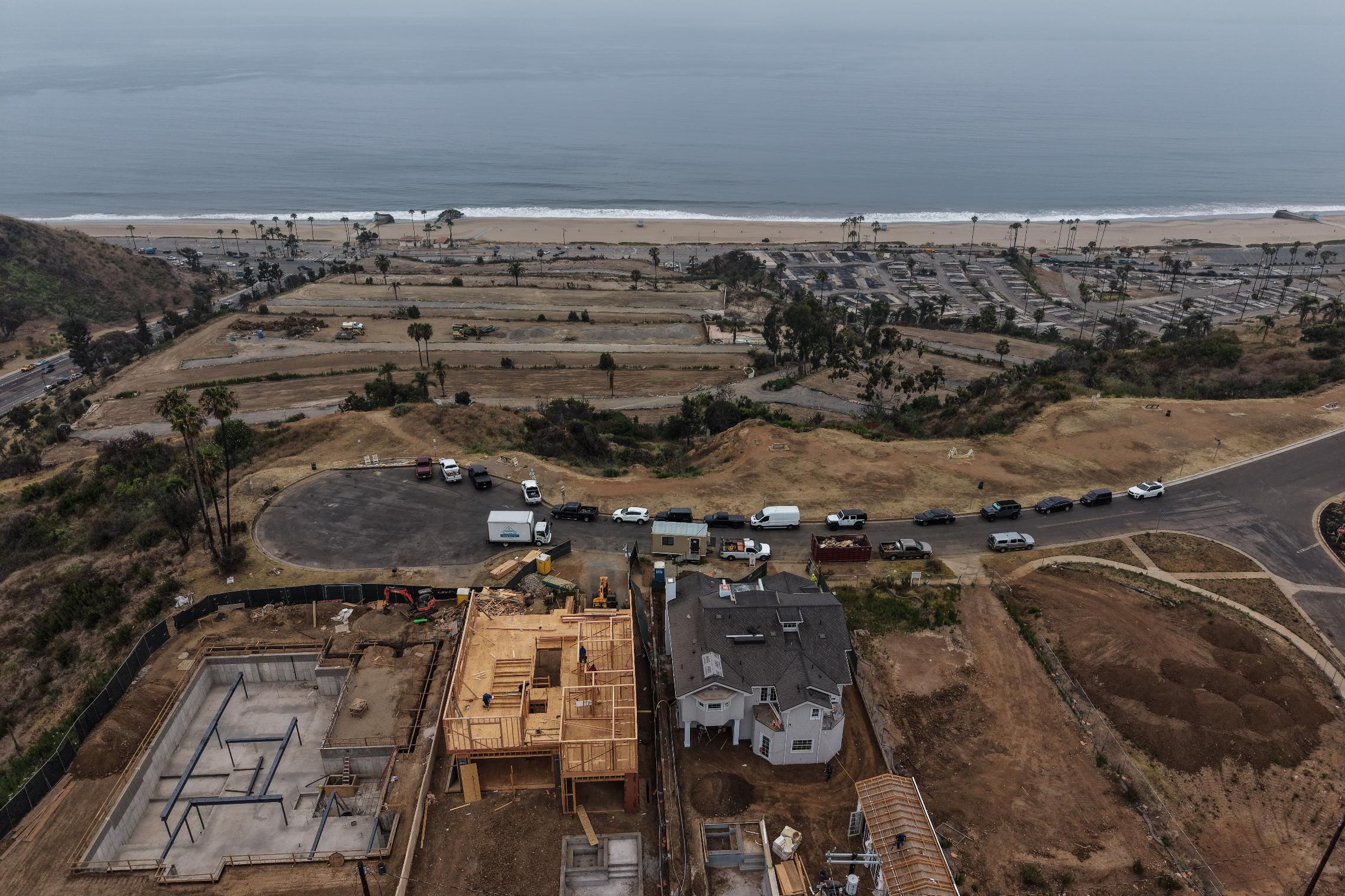 Homes under construction sit on a hillside overlooking the Pacific Ocean more than a year after the Palisades Fire in the Pacific Palisades neighborhood of Los Angeles, Thursday, June 4, 2026. (AP Photo/Jae C. Hong)
