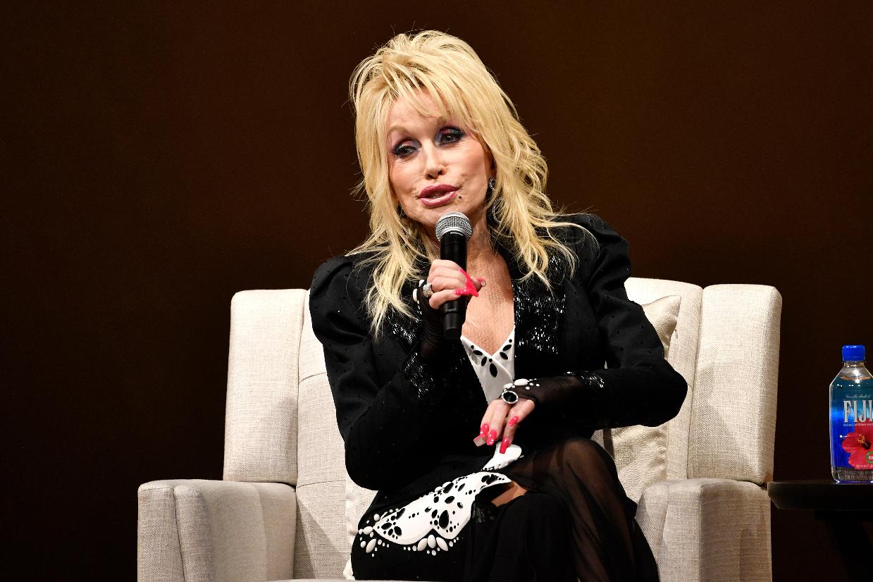 FILE - Dolly Parton speaks to a audience gathered o celebrate the expansion of the Imagination Library of Kentucky at the Lyric Theatre in Lexington, Ky., Aug. 27, 2024. (AP Photo/Timothy D. Easley, File)