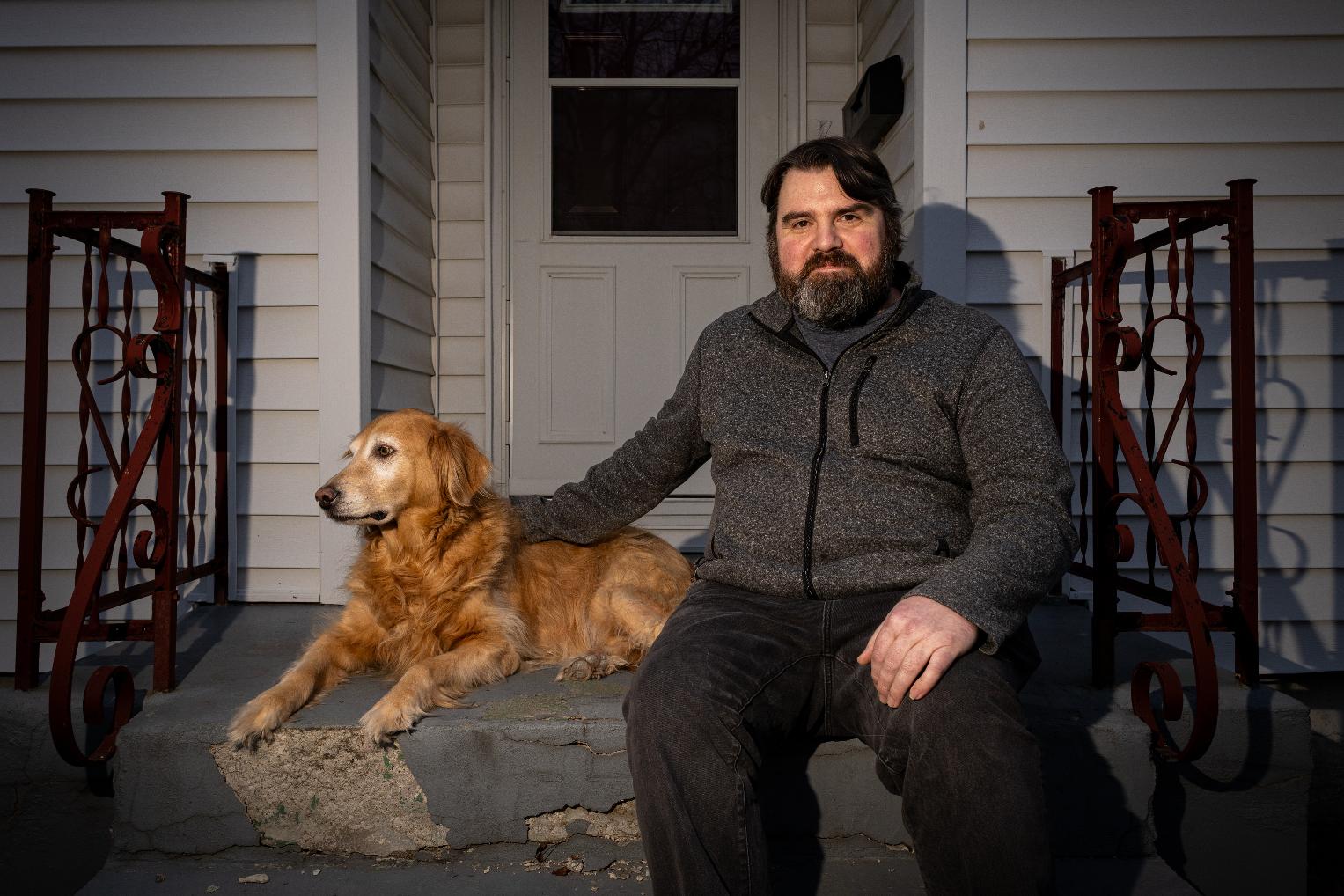 Dustin Wood, a former English teacher at the Calo Programs Residential Treatment Center, poses with his dog Moana, a former Calo therapy dog, on Feb 25, 2026, outside his home in Eldon, Mo. (AP Photo/Austin Johnson)