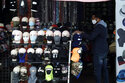 FILE - In this Friday, March 20, 2020, file photo, a merchant displays masks for sale in Los Angeles. Retail analysts expect mask sales will get another jolt after the Centers for Disease Control and Prevention late Tuesday, July 27, 2021, changed course on some masking guidelines, recommending that even vaccinated people return to wearing masks indoors in parts of the U.S. where cases of the coronavirus are surging. (AP Photo/Marcio Jose Sanchez, File)