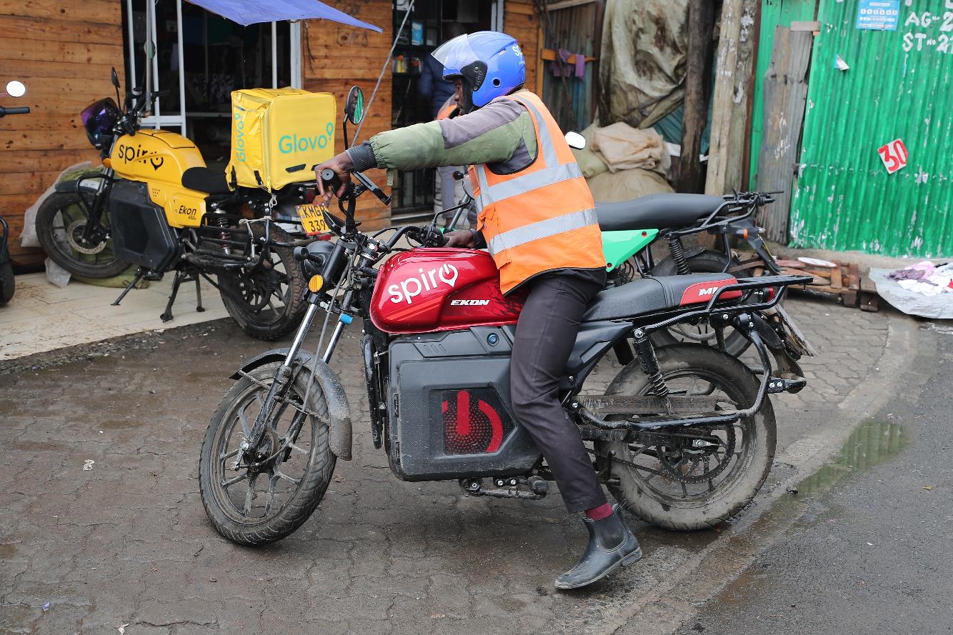 A rider sits on an electric Spiro motorcycle in Nairobi, Kenya, Tuesday, Feb. 24, 2026. (AP Photo/Henry Naminde)