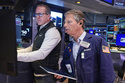 Specialist Glenn Carell, left, and trader Robert Charmak work on the floor of the New York Stock Exchange, Friday, May 22, 2026. (AP Photo/Richard Drew)