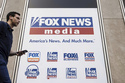 FILE - A person walks past the Fox News Headquarters in New York on April 12, 2023. (AP Photo/Yuki Iwamura, File)
