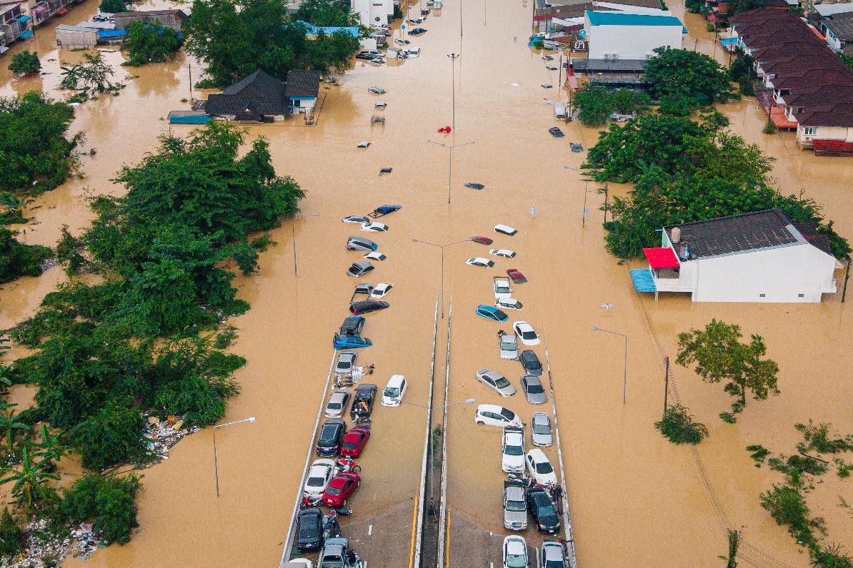 FILE - Cars and houses are submerged in floodwaters in Songkhla province, southern Thailand, on Nov. 26, 2025. (AP Photo/Arnun Chonmahatrakool, File)