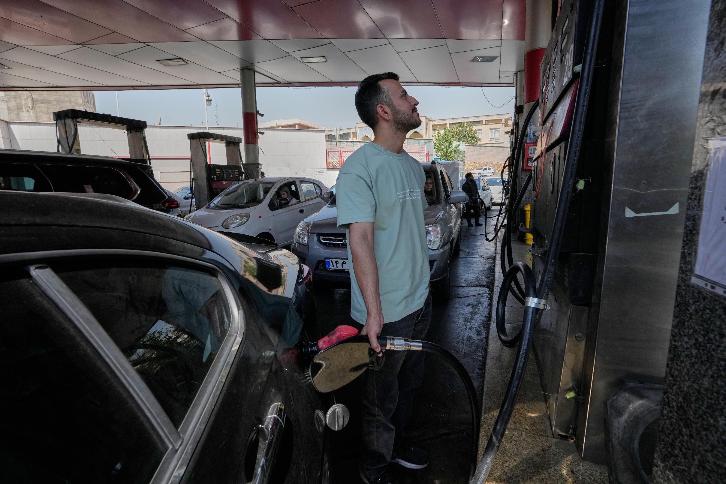 A man is filling up his car at a gas station in Tehran, Iran, Tuesday, Aug. 25, 2026. (AP Photo/Vahid Salemi)