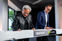 Jensen Huang, left, president and CEO of Nvidia, and Jim Anderson, CEO of Coherent, sign a ceremonial construction beam before a groundbreaking ceremony for an expansion of Coherent's manufacturing facility on Tuesday, June 16, 2026, in Sherman, Texas. (AP Photo/Jeffrey McWhorter)