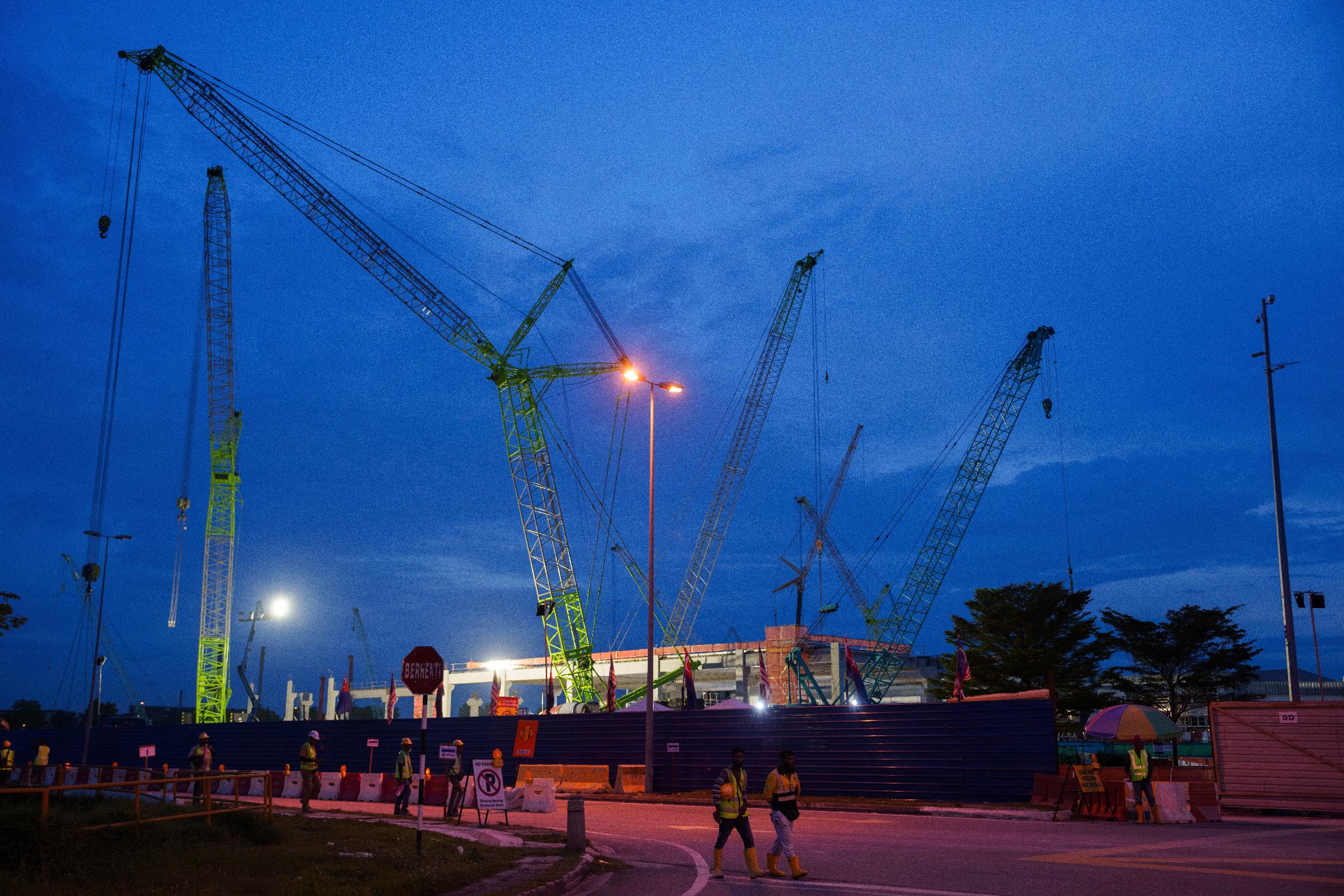 FILE - Workers walk outside a data center building under construction in Johor Bahru town at Johor state, Sept. 28, 2024. (AP Photo/Vincent Thian, File)
