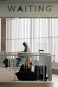 People wait in a departure terminal at Ronald Reagan National Airport, in Arlington, Va., Monday, March 16, 2026. (AP Photo/Cliff Owen)