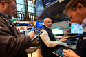 James Denaro, center, and others work on the floor at the New York Stock Exchange in New York, Monday, March 2, 2026. (AP Photo/Seth Wenig)