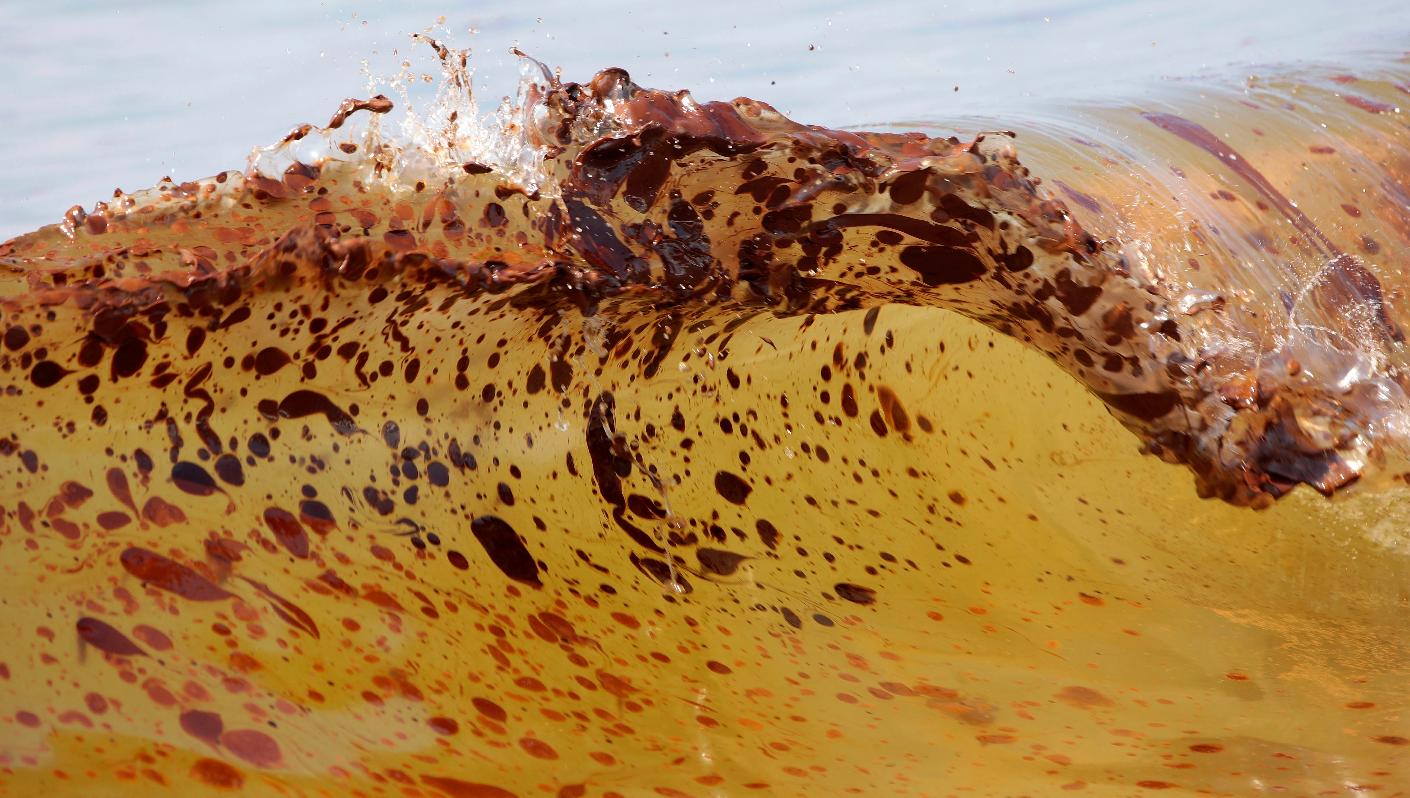 FILE - Crude oil from the Deepwater Horizon oil spill washes ashore in Orange Beach, Ala., on June 12, 2010. (AP Photo/Dave Martin, File)