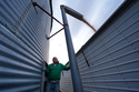 Doug Bartek transfers soybeans from a storage bin to a truck on his farm near Wahoo, Neb., on Monday, April 6, 2026. (AP Photo/Charlie Riedel)