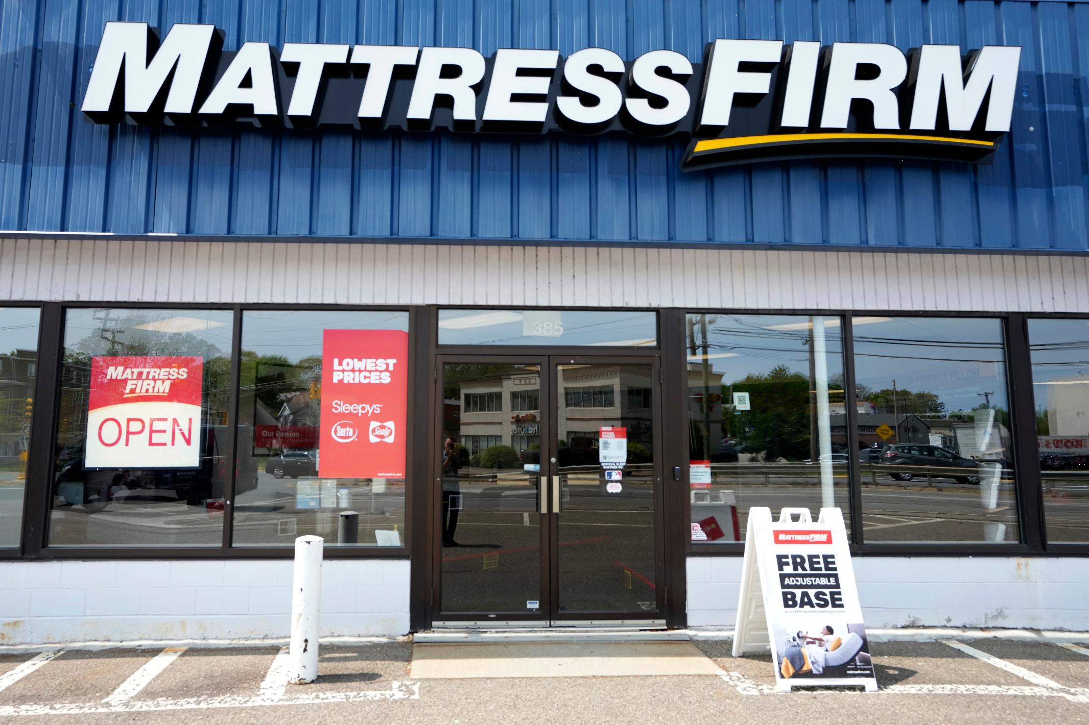 A Mattress Firm store location has an open sign in a window, Tuesday, May 9, 2023, in Dedham, Mass. Tempur Sealy has agreed to acquire Mattress Firm in a cash-and-stock transaction valued at about $4 billion. The companies said Tuesday they expect to complete the transaction in the second half of 2024. (AP Photo/Steven Senne)