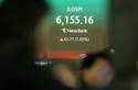 Dealers work near the screen showing the Korea Composite Stock Price Index (KOSPI) at a dealing room of Hana Bank, in Seoul, South Korea, Thursday, April 16, 2026. (AP Photo/Lee Jin-man)