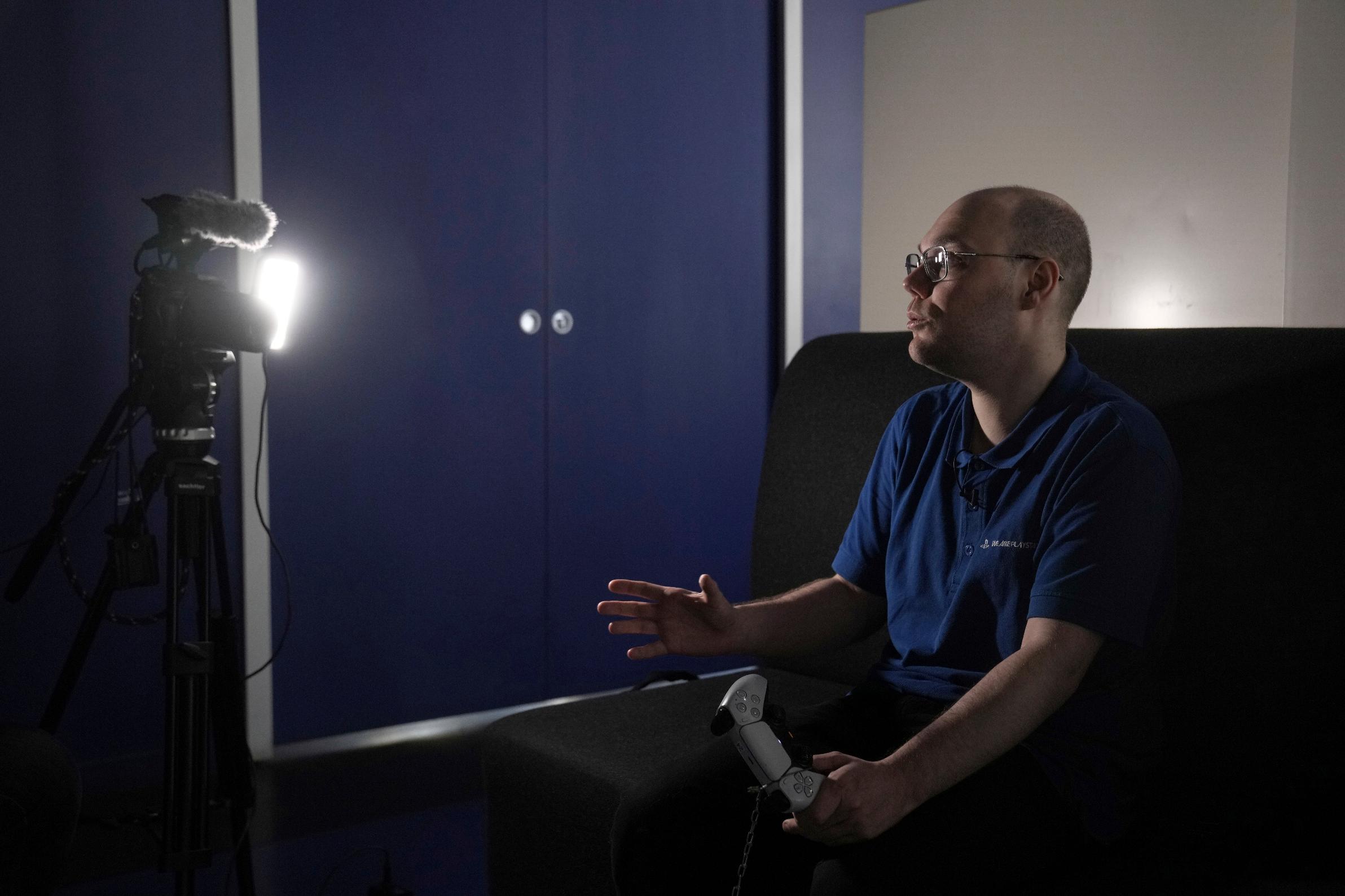 Romain Bos poses in a game center, in Paris, France, Friday, Sept. 20, 2025. (AP Photo/Thibault Camus)
