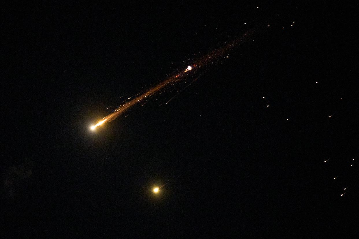 An Iranian cluster munition missile explodes in the sky over northern Israel, Wednesday, April 8, 2026. (AP Photo/Ariel Schalit)