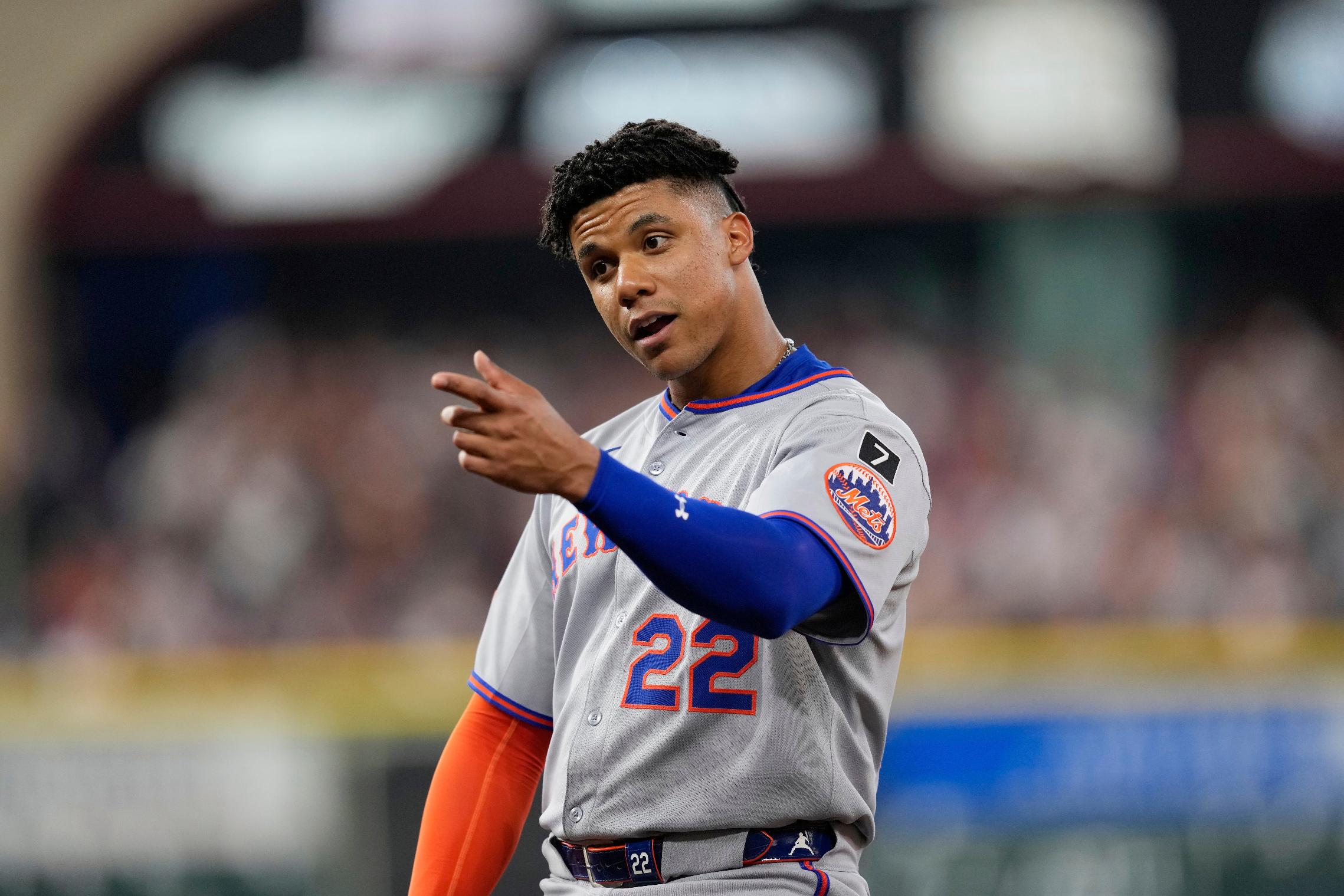 New York Mets' Juan Soto talks to Houston Astros players in the dugout during the middle of the third inning of a baseball game Saturday, March 29, 2025, in Houston. (AP Photo/David J. Phillip)
