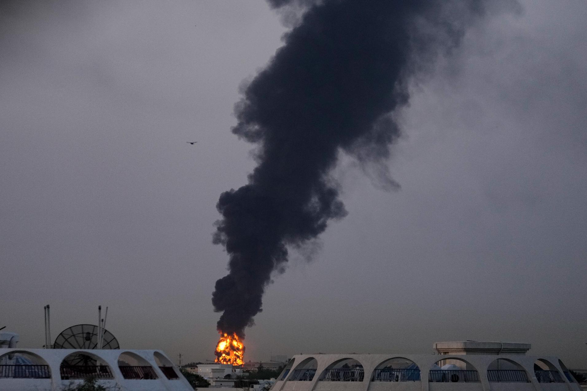 Fire and plumes of smoke rise after a drone struck a fuel tank forcing the temporary suspension of flights. near Dubai International Airport, in United Arab Emirates, early Monday, March 16, 2026. (AP Photo)