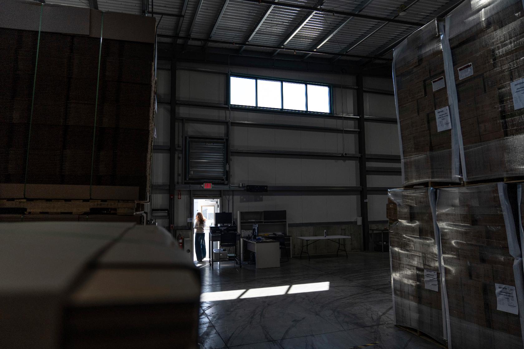Edesia Nutrition CEO Navyn Salem leaves a warehouse storing shipping boxes of Plumpy'Nut, a nutritional lifesaving peanut paste sent to malnourished children worldwide, Friday, March 14, 2025, in North Kingstown, R.I. (AP Photo/David Goldman)
