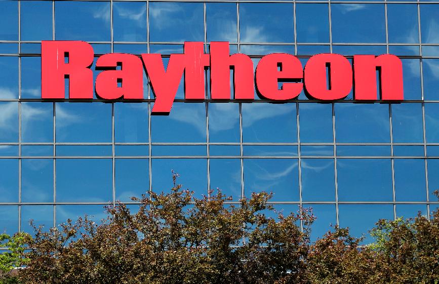 FILE - The sky is reflected on the facade of Raytheon's Integrated Defense Systems facility, Monday, June 10, 2019, in Woburn, Mass. (AP Photo/Elise Amendola, File)