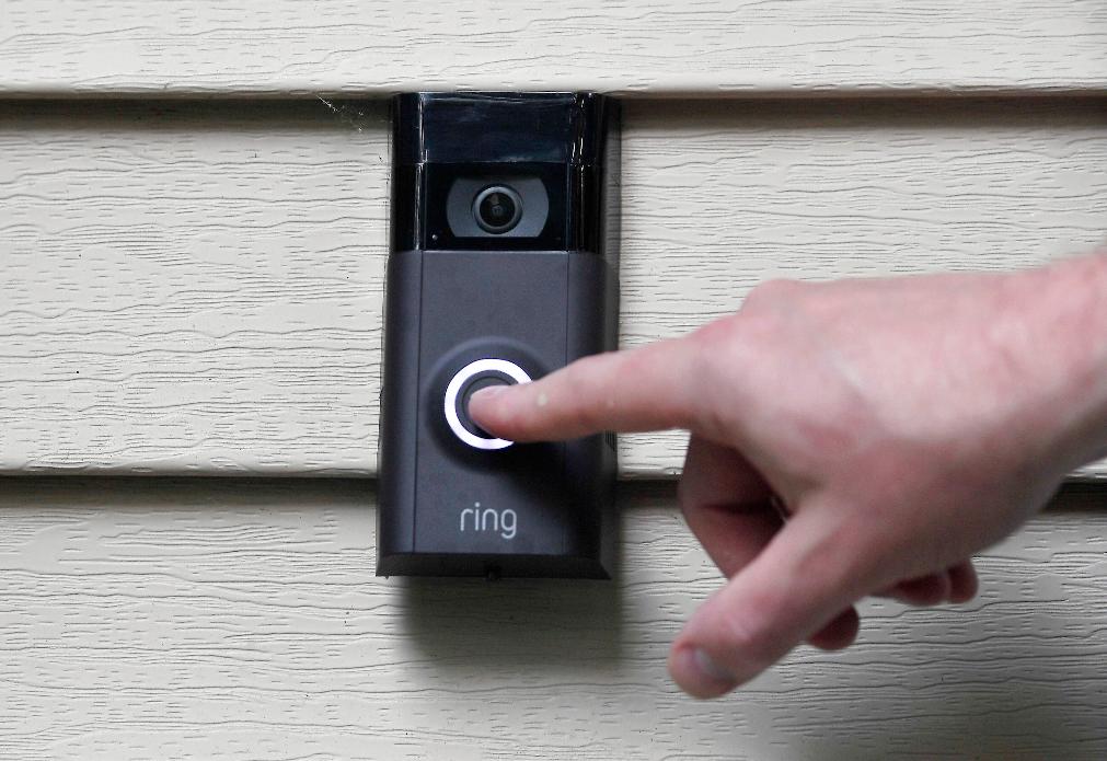 FILE - A person pushes the doorbell on their Ring doorbell camera, July 16, 2019, in Wolcott, Conn. (AP Photo/Jessica Hill, File)