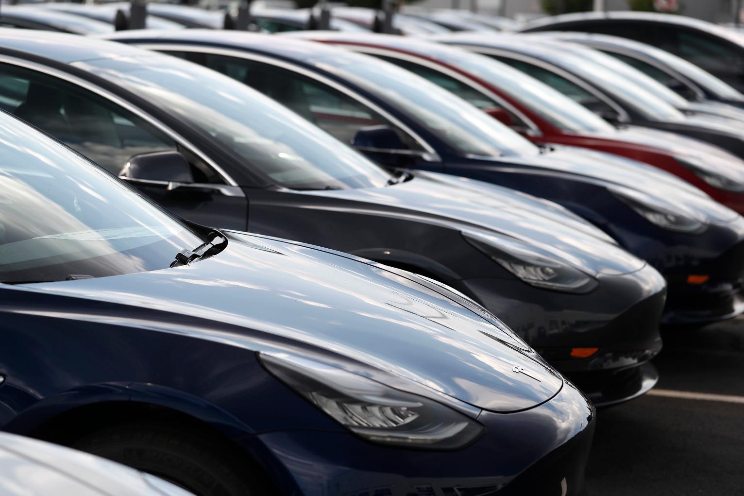 FILE - Several 2018 Model 3 sedans sit on display outside a Tesla showroom, July 8, 2018, in Littleton, Colo. (AP Photo/David Zalubowski, File)