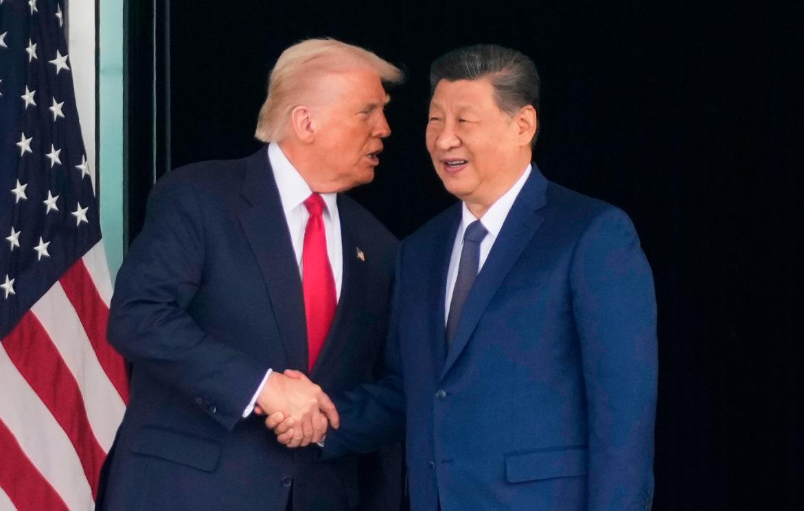 FILE - President Donald Trump, left, and Chinese President Xi Jinping, shake hands after their U.S.-China summit talk at Gimhae International Airport Jinping in Busan, South Korea, Oct. 30, 2025. (AP Photo/Mark Schiefelbein, File)