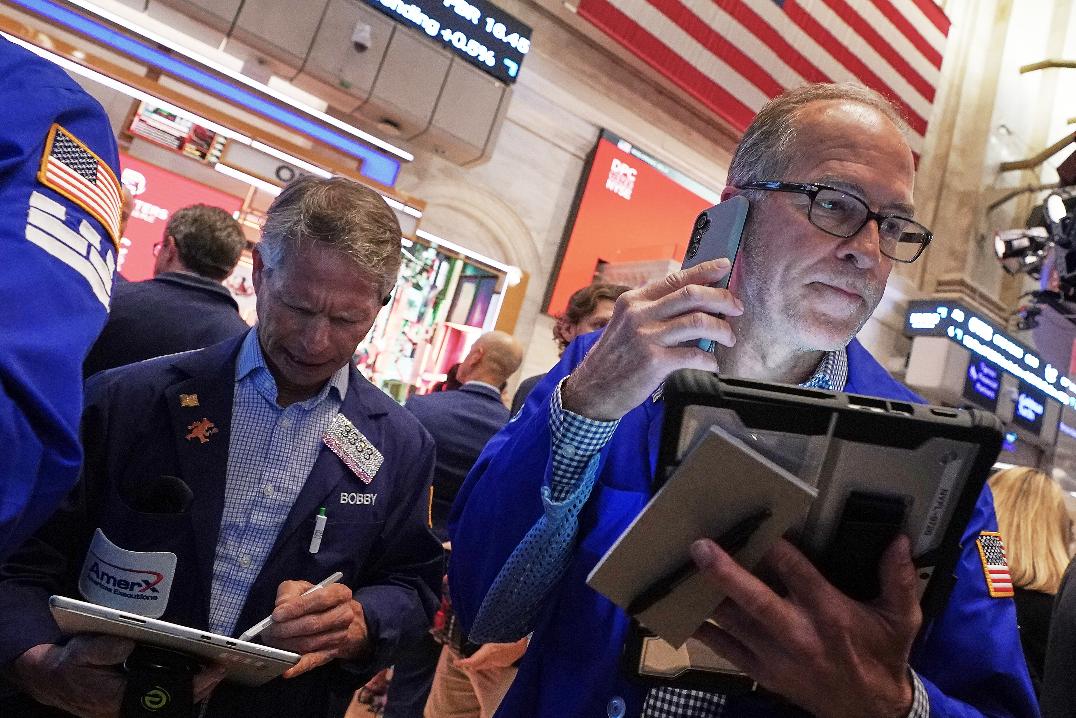 Traders Robert Charmak, left, and Mark Puetzer work on the floor of the New York Stock Exchange, Thursday, June 25, 2026. (AP Photo/Richard Drew)