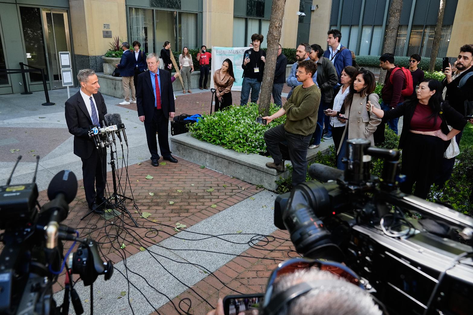 William Savitt, attorney representing OpenAI, left, speaks during a press conference outside the U.S. District Court in Oakland, Calif., Thursday, April 30, 2026. (AP Photo/Godofredo A. Vásquez)