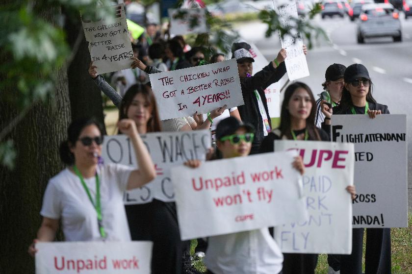 Striking Air Canada flight attendants rally at Vancouver International Airport, in Richmond, British Columbia, Monday, Aug. 18, 2025. (Darryl Dyck/The Canadian Press via AP)