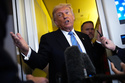 President Donald Trump speaks to reporters aboard Air Force One, Friday, May 15, 2026, as he returns from a trip to Beijing, China. (AP Photo/Mark Schiefelbein)