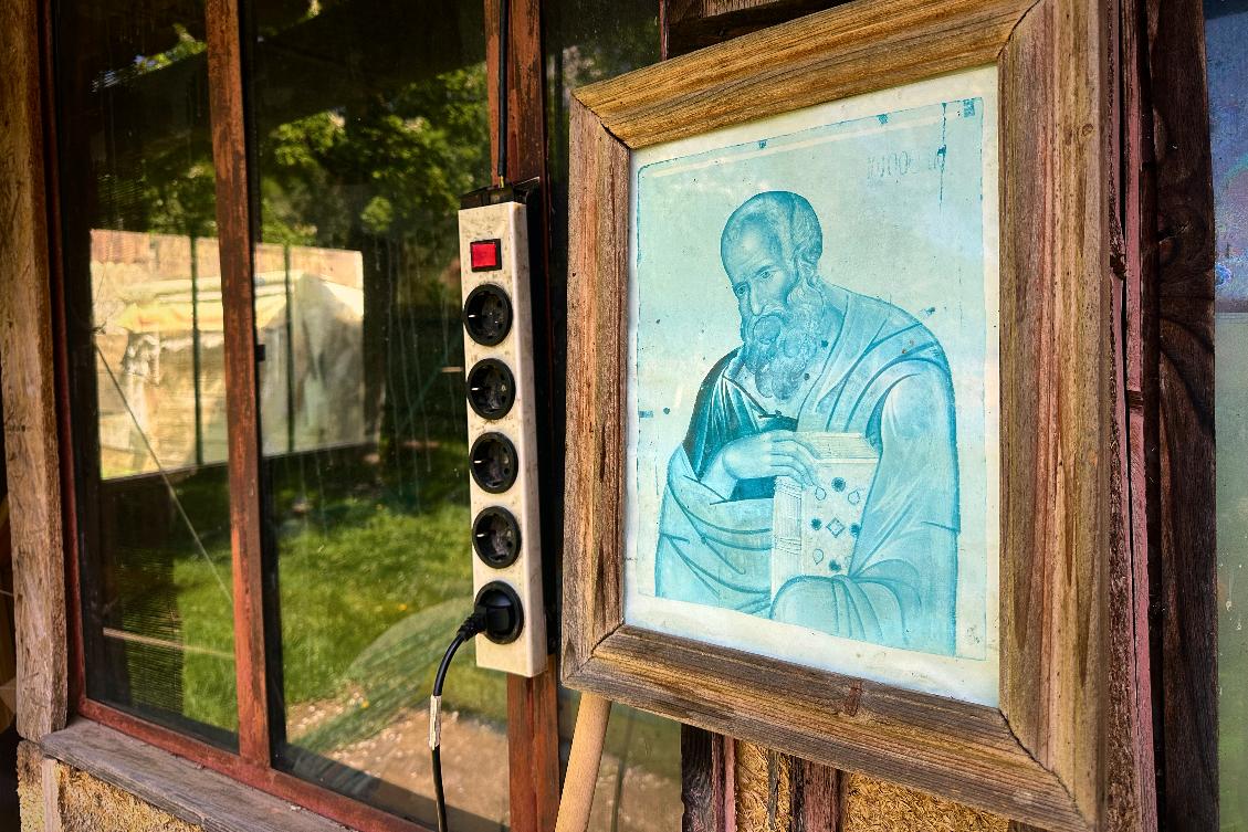 A picture of a religious icon hangs on the wall of a courtyard building at the home of Liliana Cosurean, 54, in the village of Floresti, in Romania's central Transylvania region, Thursday, April 24, 2025. (AP Photo/Stephen McGrath)