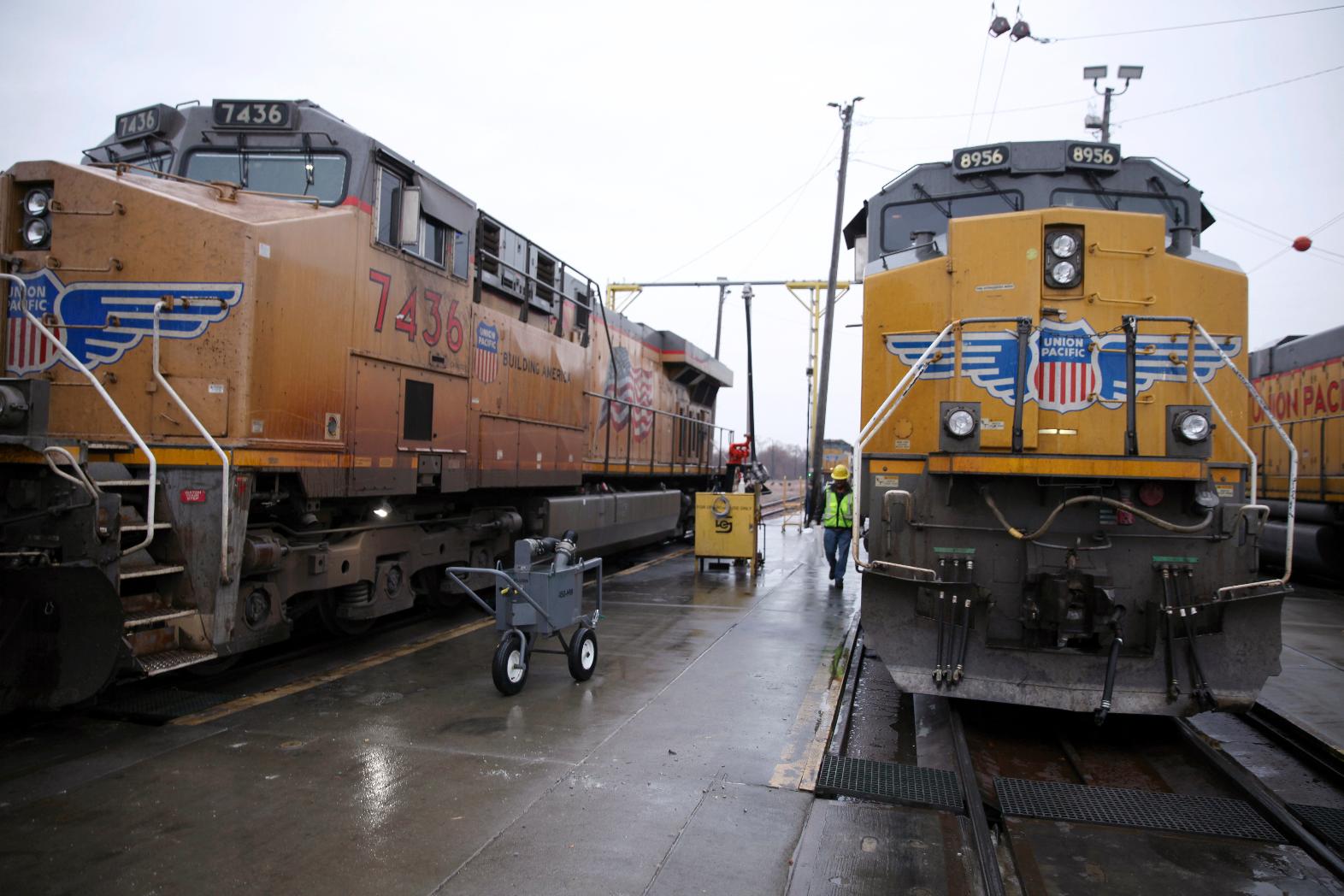 FILE - A Union Pacific worker walks between two locomotives that are being serviced in a railyard in Council Bluffs, Iowa, on Dec. 15, 2023. (AP Photo/Josh Funk, File)