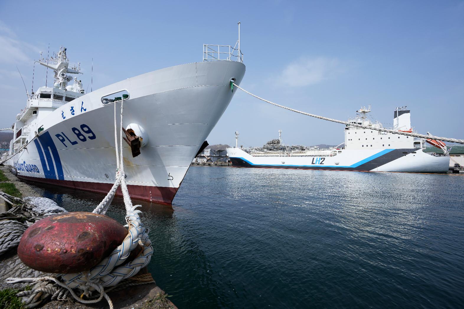 The Suiso Frontier, back right, a liquefied hydrogen carrier, is berthed as a Japan Coast Guard ship is docked to watch the area in Otaru, northern Japan, Friday, April 14, 2023. U.S. Energy Secretary Jennifer Granholm took a tour Friday on the liquefied hydrogen carrier, the day before the G-7 ministers' meeting on climate, energy and environment. (AP Photo/Hiro Komae)