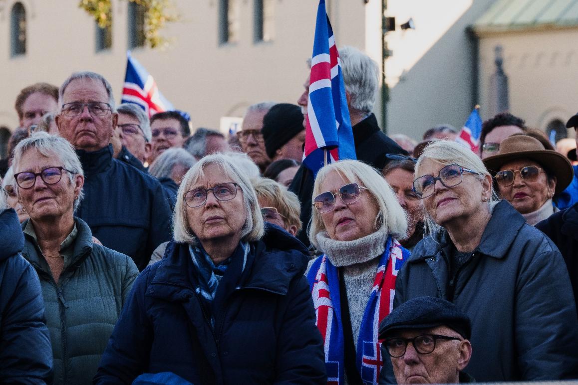 People listen to speakers at an "Afram Island," "Forward, Iceland" rally opposing the resumption of European Union accession talks at Austurvollur in Reykjavik, Iceland, Thursday, Aug. 27, 2026. (AP Photo/Marco Di Marco)