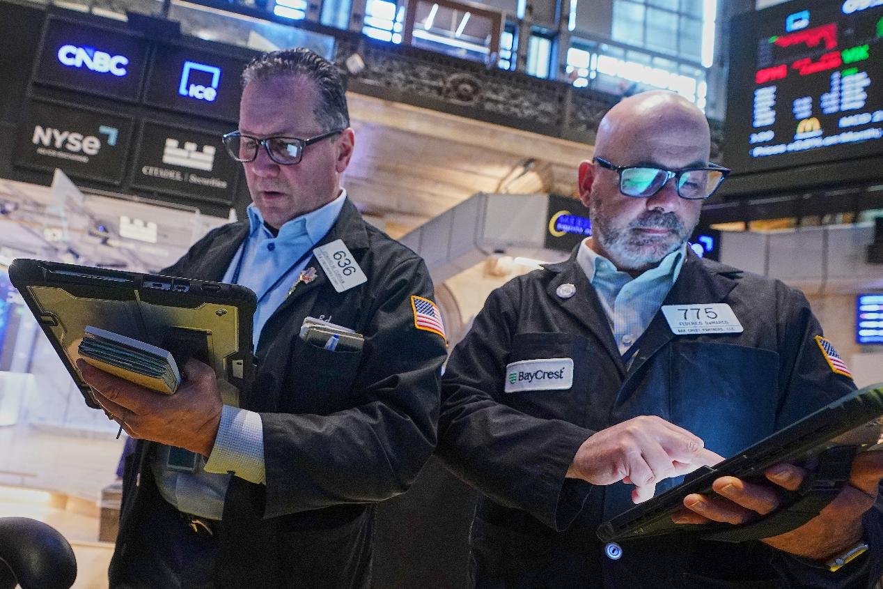 Traders Edward Curran, left, and Fred Demarco work on the floor of the New York Stock Exchange, Wednesday, June 3, 2026. (AP Photo/Richard Drew)