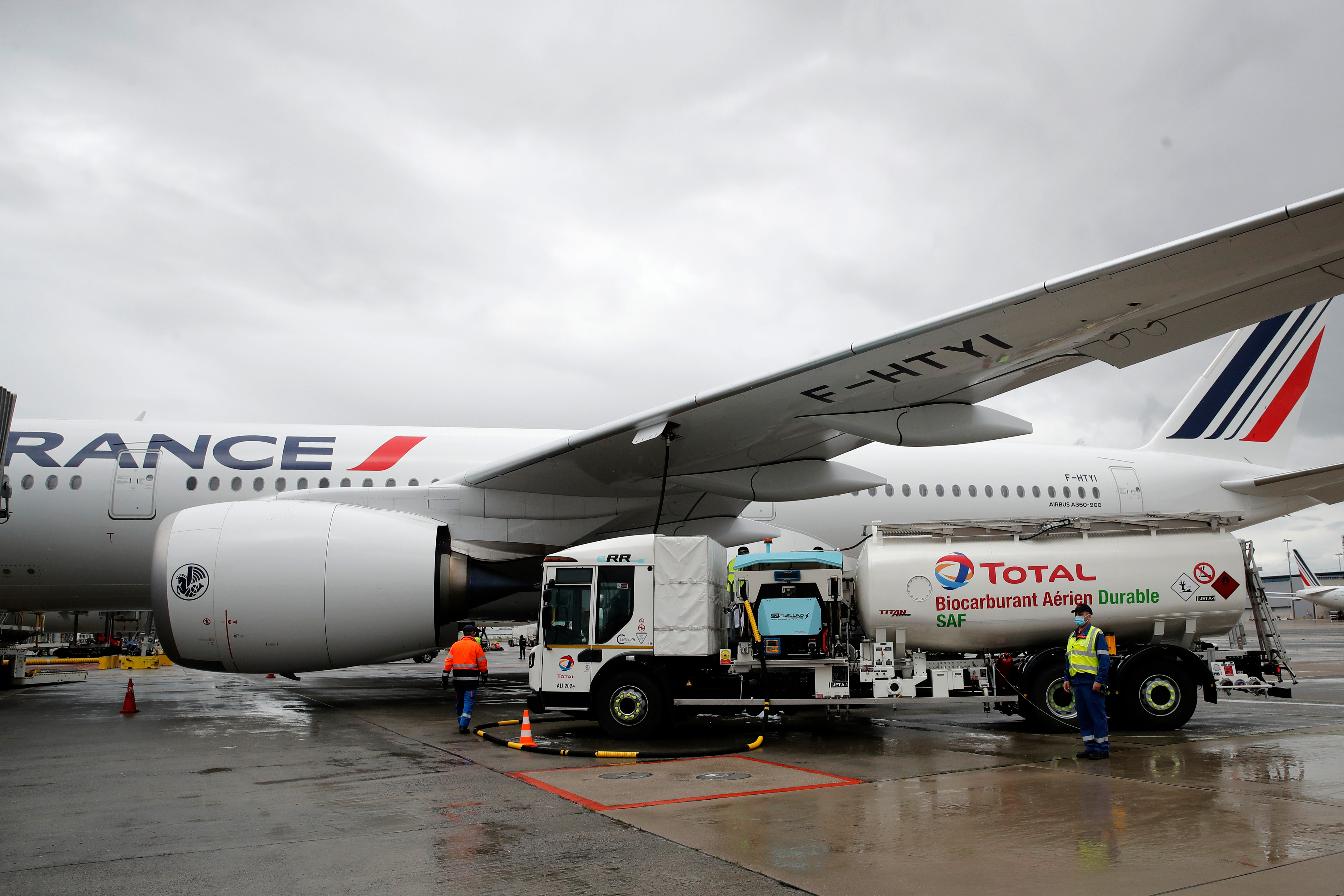 FILE - Workers refuel an Airbus A350 with sustainable aviation fuel at Roissy airport, north of Paris, Tuesday, May 18, 2021. (AP Photo/Christophe Ena, File)