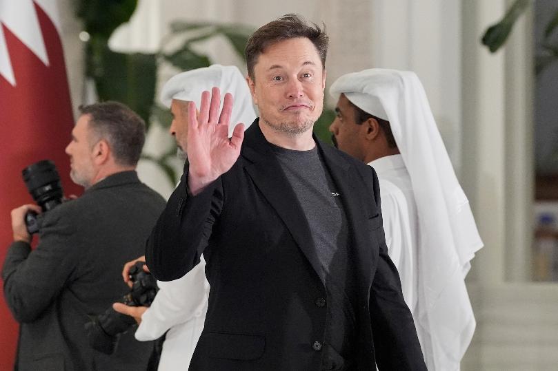 Elon Musk gestures as he arrives for a state dinner hosted by Qatar's Emir Sheikh Tamim bin Hamad Al Thani in honor of President Donald Trump at Lusail Palace in Doha, Qatar, Wednesday, May 14, 2025. (AP Photo/Alex Brandon)