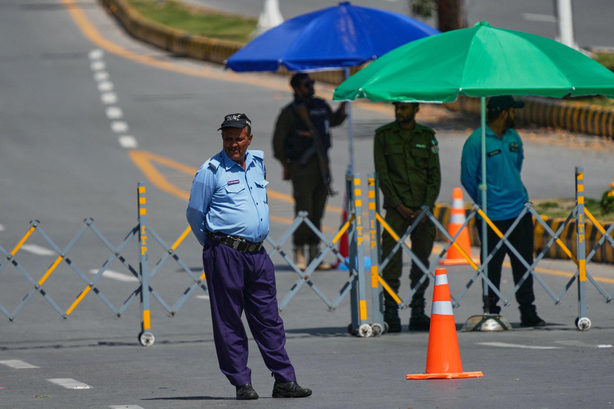 Police officers stand guard at a checkpoint to ensure security in Islamabad, Pakistan, Wednesday, April 22, 2026. (AP Photo/Anjum Naveed)