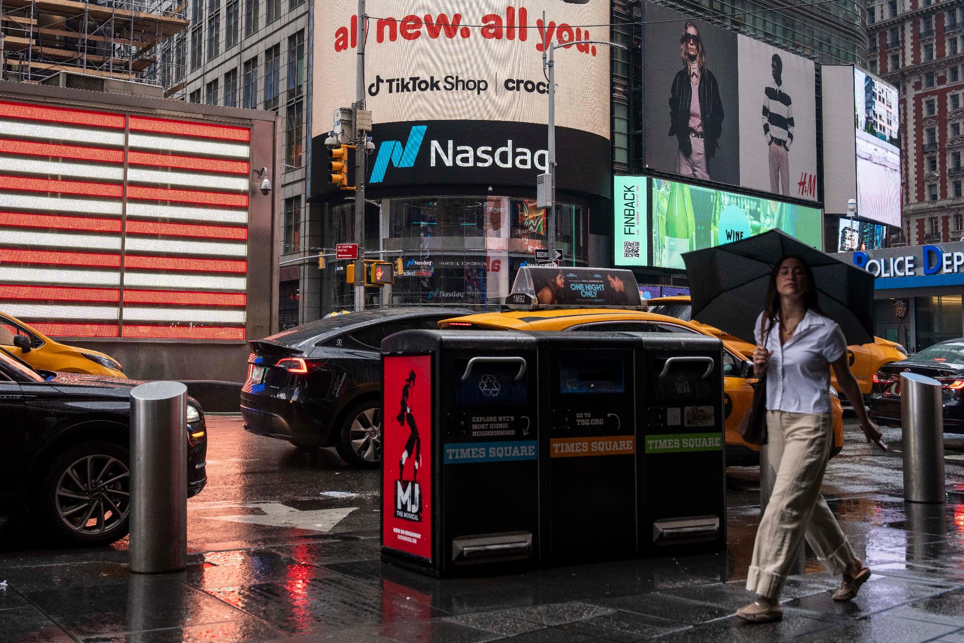 People walk past the Nasdaq MarketSite, Thursday, Aug. 6, 2026, in New York. (AP Photo/Yuki Iwamura)