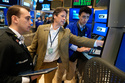 Patrick McKeon, center, works on the floor at the New York Stock Exchange in New York, Tuesday, March 31, 2026. (AP Photo/Seth Wenig)