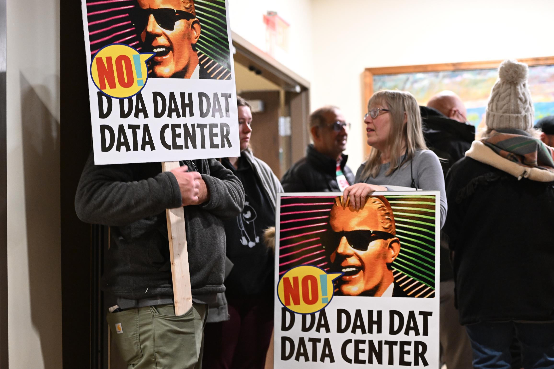 FILE - People opposed to a data center proposal at the former Pennhurst state hospital grounds talk during a break in an East Vincent Township supervisors meeting, Dec. 17, 2025, in Spring City, Pa. (AP Photo/Marc Levy, file)